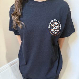 Person wearing short sleeved black shirt with Monacan Humanities logo